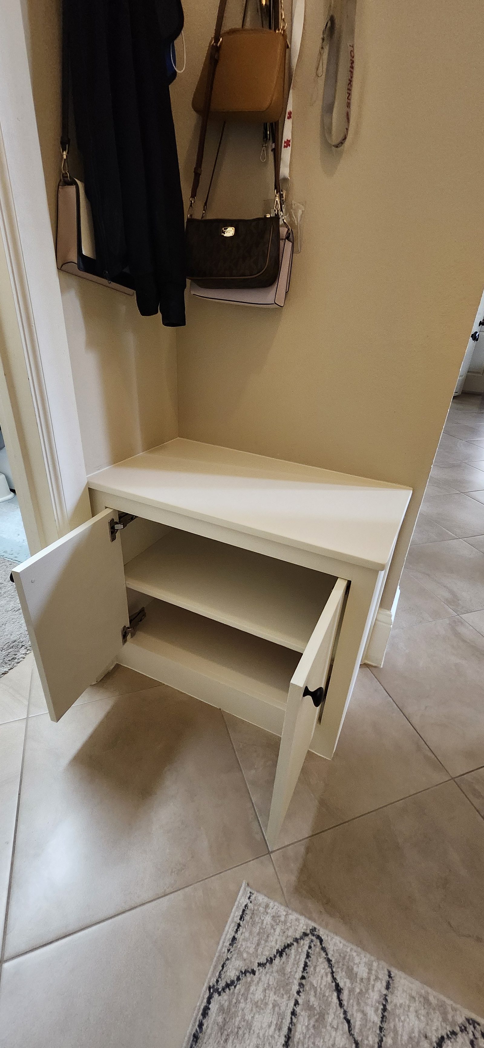 Built-in storage bench with cabinet doors open in Katy, TX