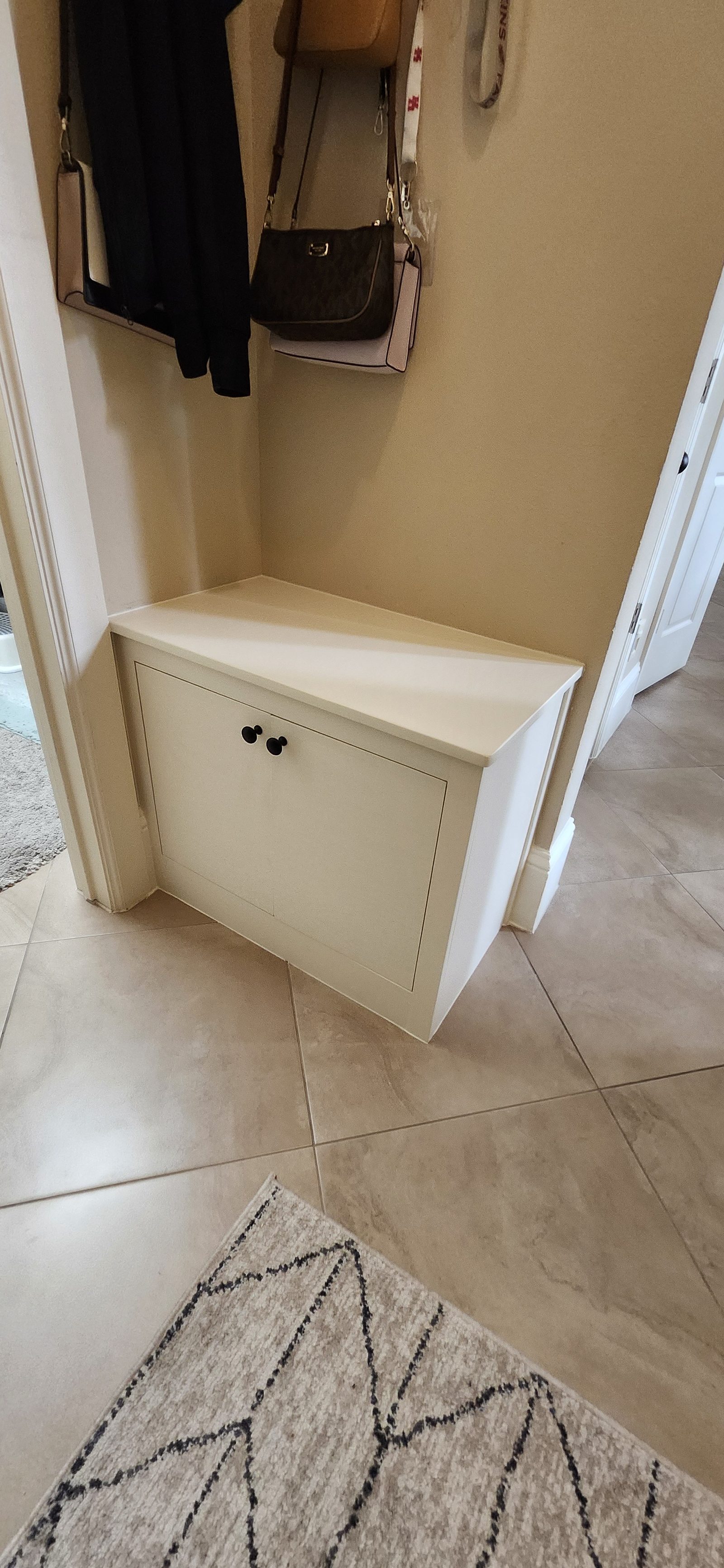 Built-in storage bench with cabinet doors closed in Katy, TX
