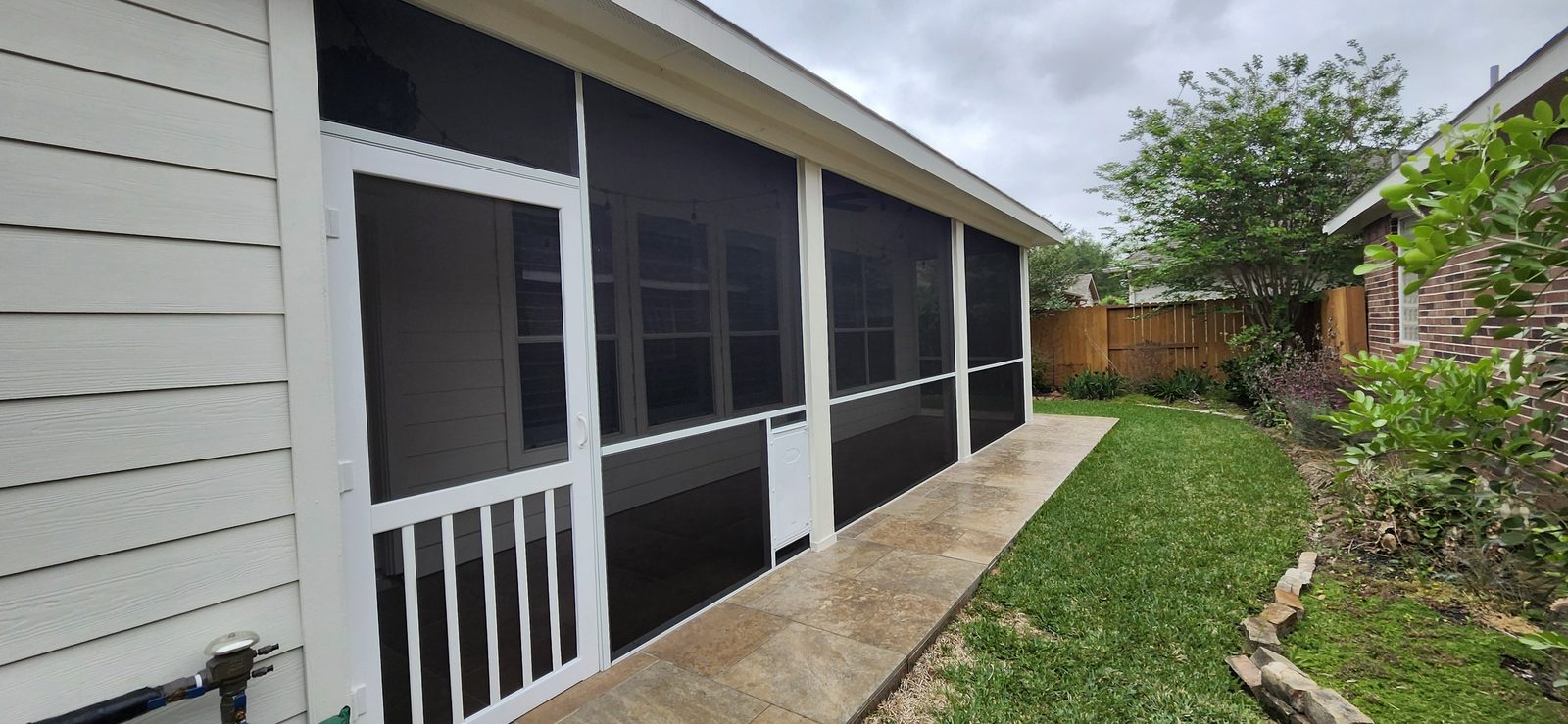 Screened patio enclosure built onto the back of a home in Katy, TX