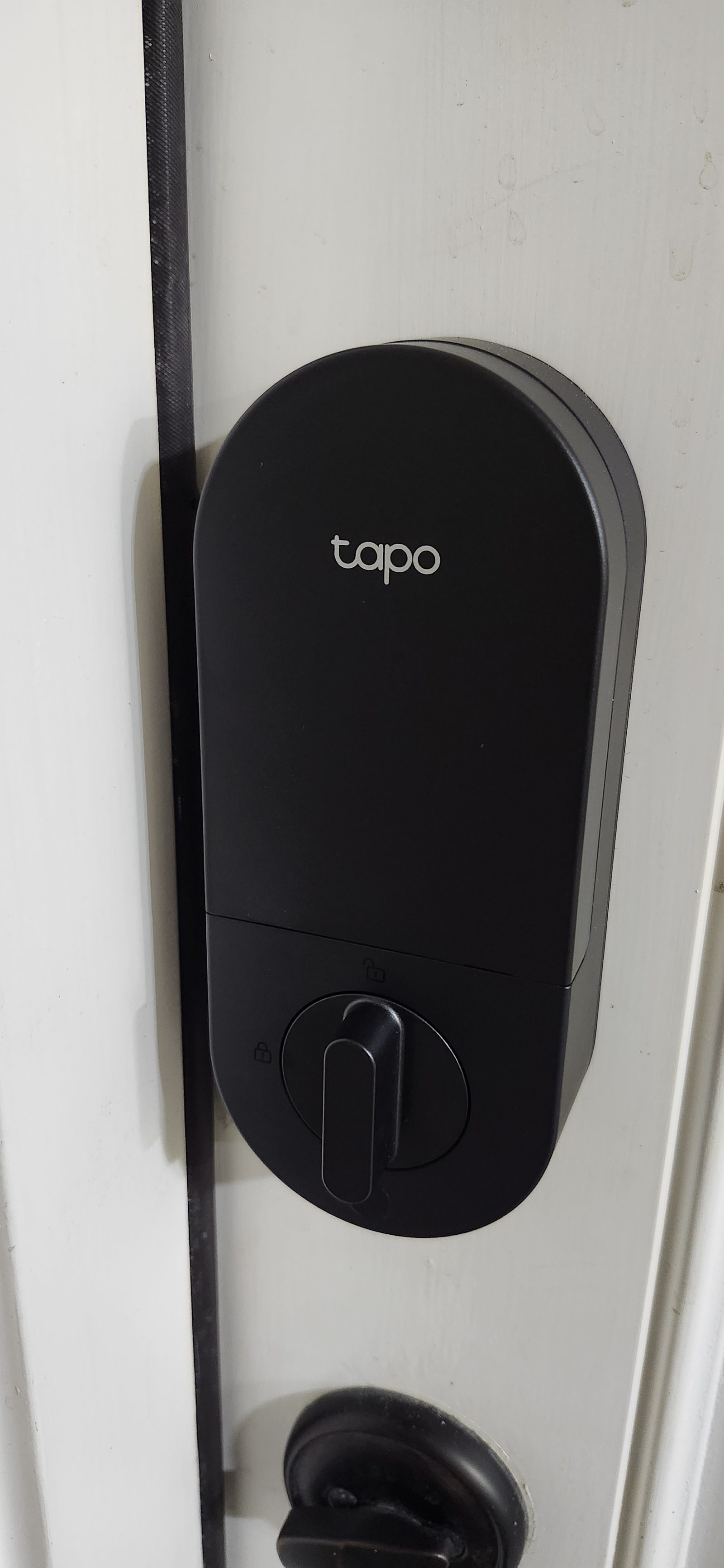 Smart Tapo keypad deadbolt lock installed on a black door in Katy, TX