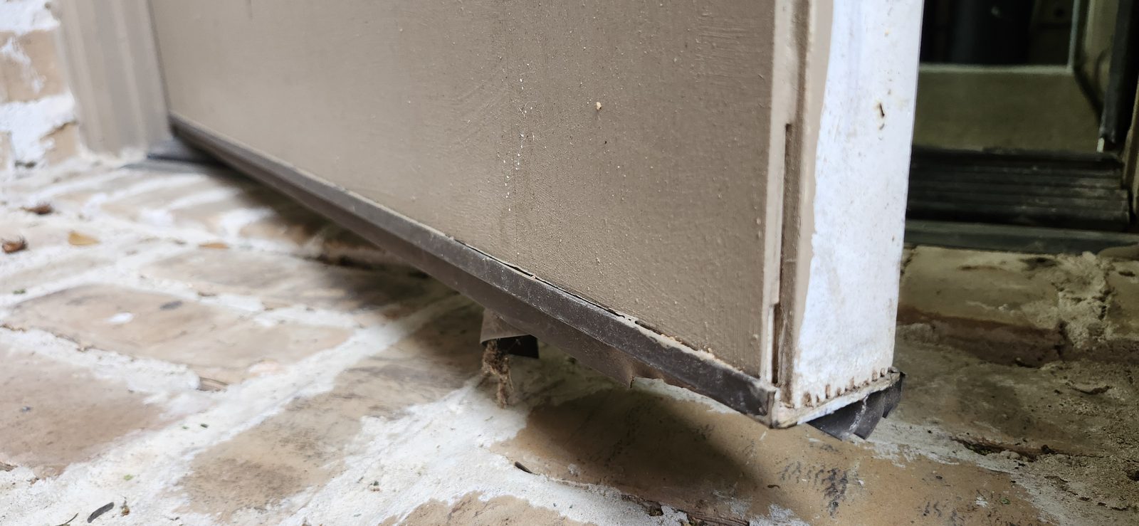 Worn bottom door weather seal before replacement in Katy, TX