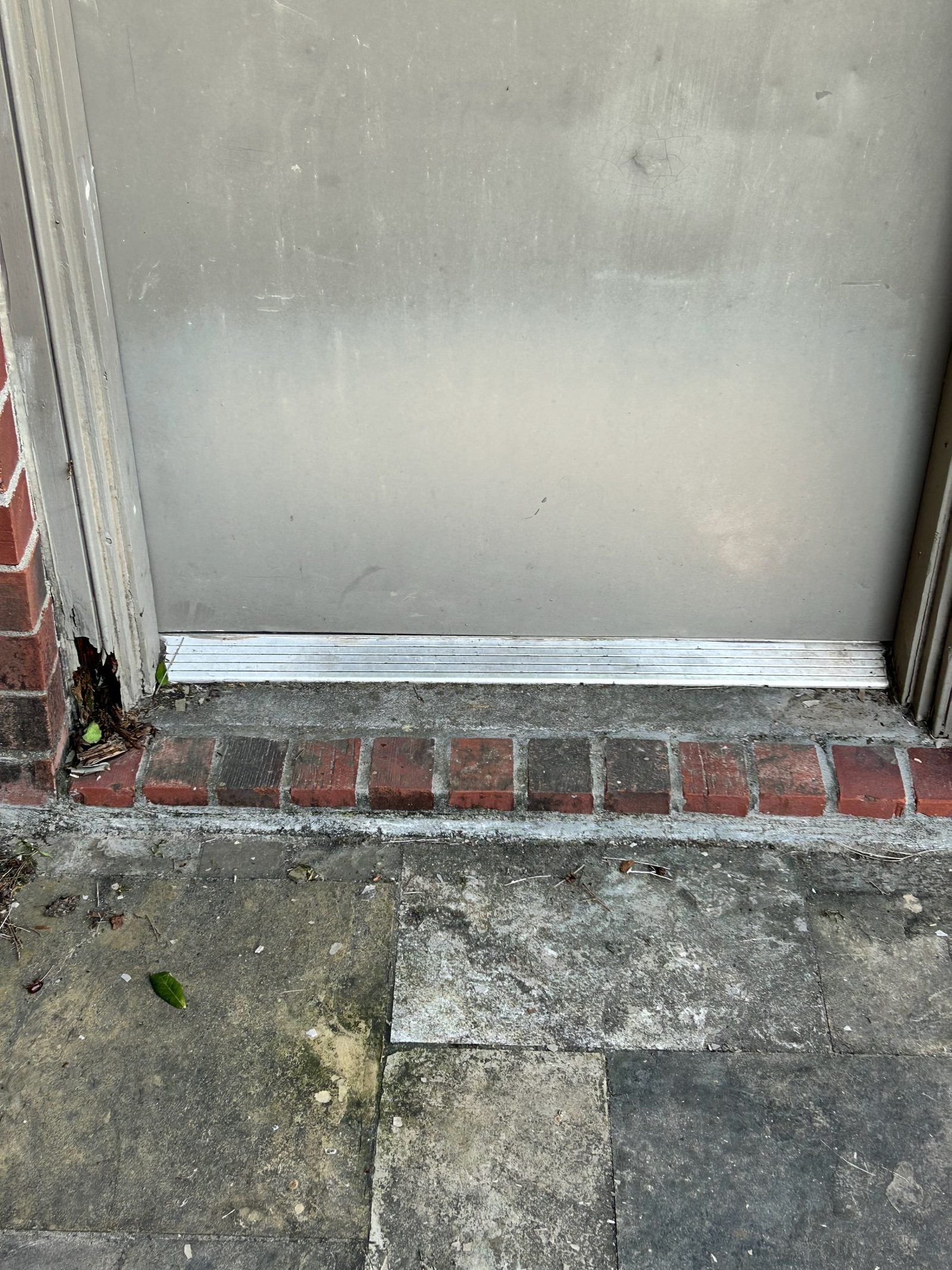 Worn door threshold and jamb before repair in Katy, TX