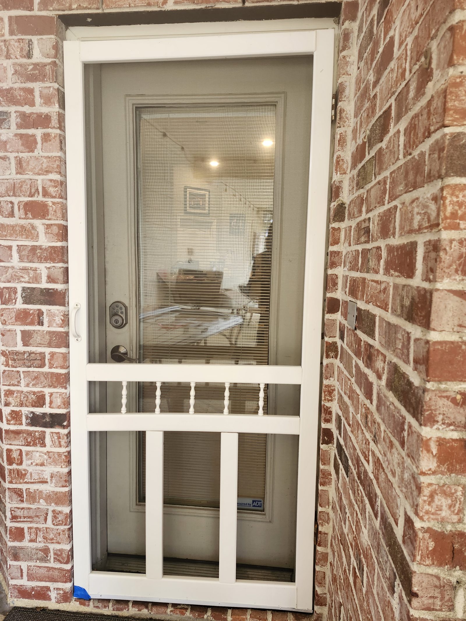 New storm door installed in a brick doorway in Katy, TX