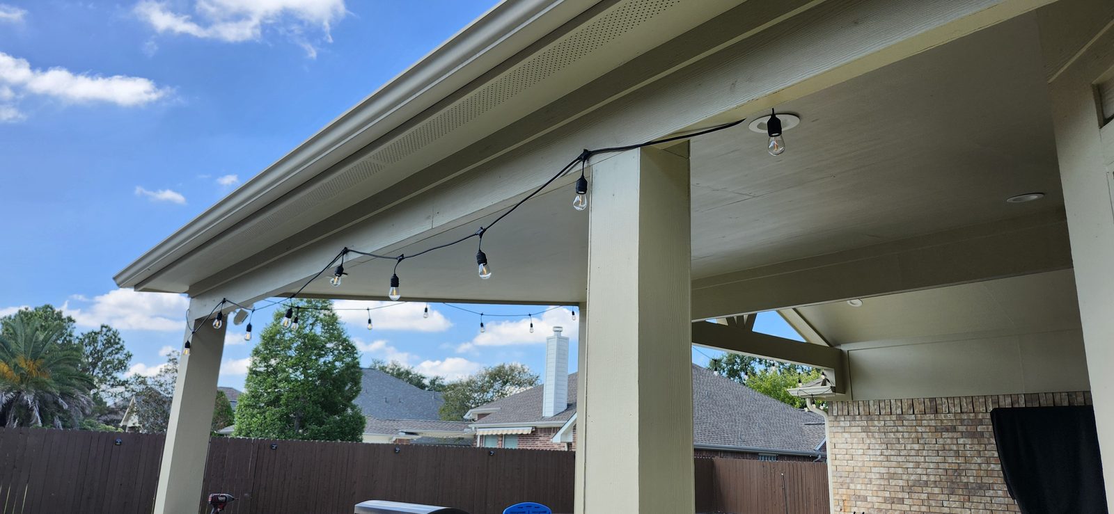 Patio string lights installed under a covered back patio in Katy, TX