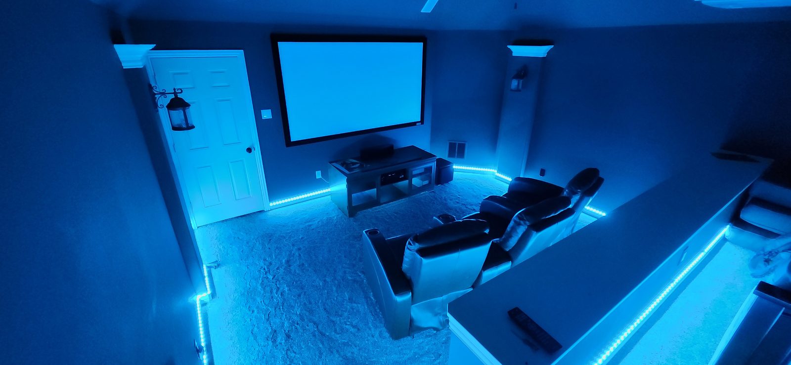 Blue LED baseboard accent lighting installed in a home theater room in Katy, TX