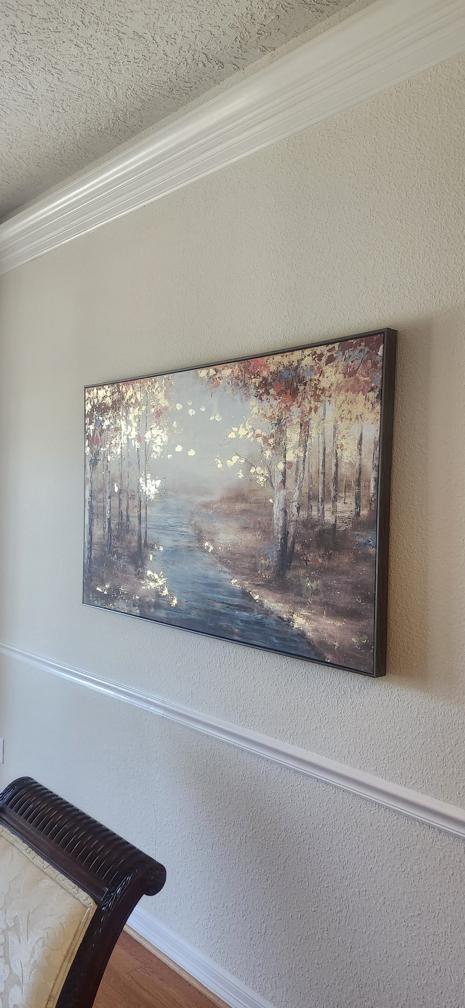 Framed art canvas hung on a living room wall in Katy, TX