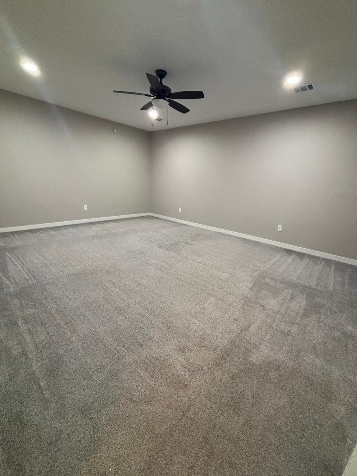 Empty bedroom with newly painted light gray walls in Katy, TX