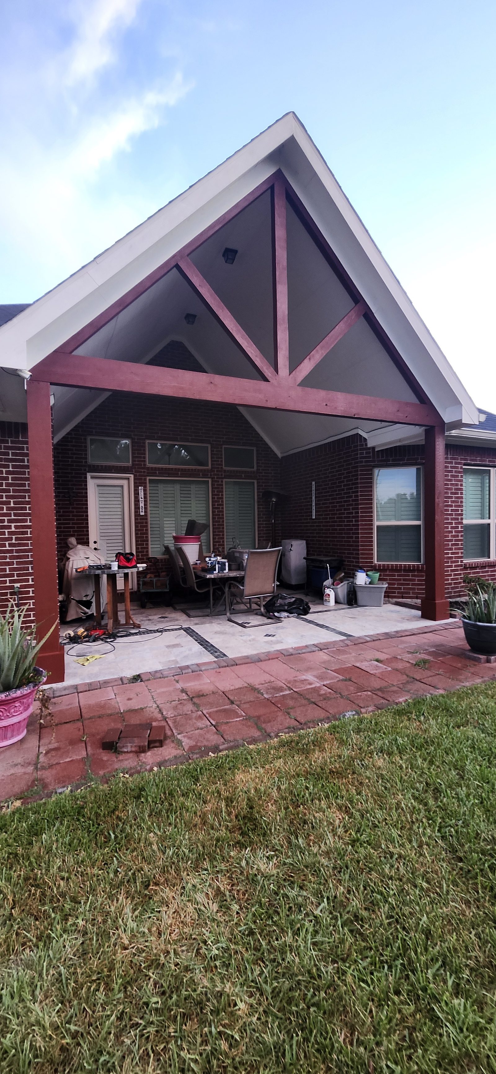 Patio cover structure with stained wood beams in Katy, TX