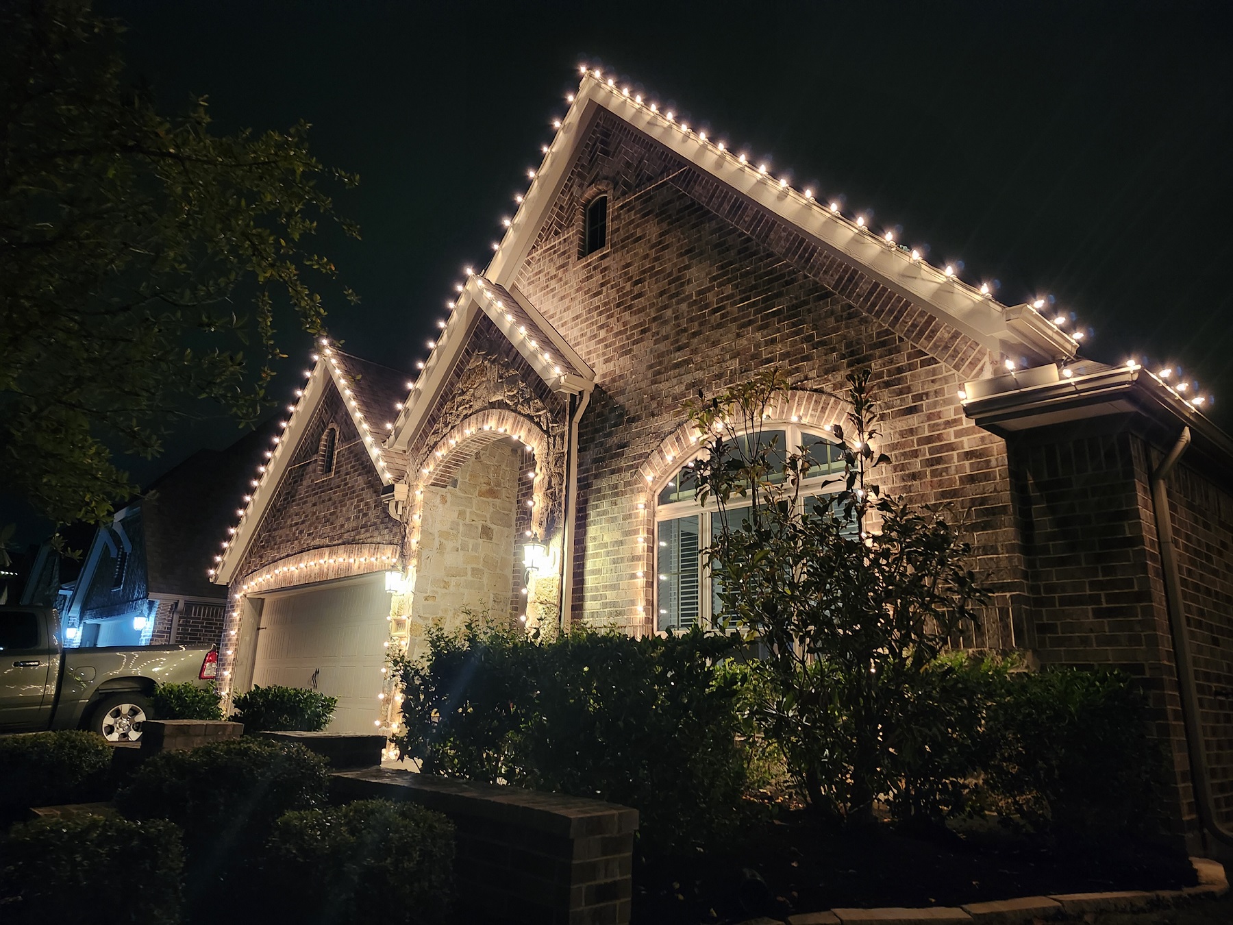 Christmas lights installation on two-story house in Katy, TX. LED Warm white