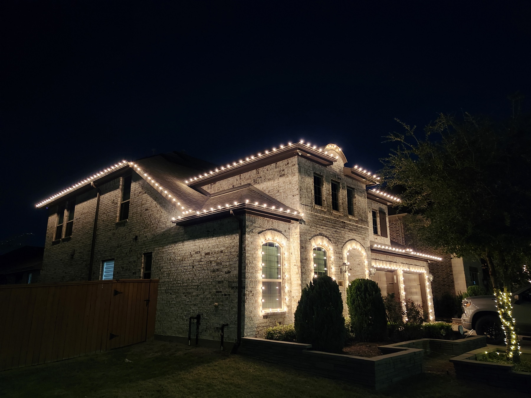 Christmas lights installation on two-story house in Katy, TX. Incandescent Warm white