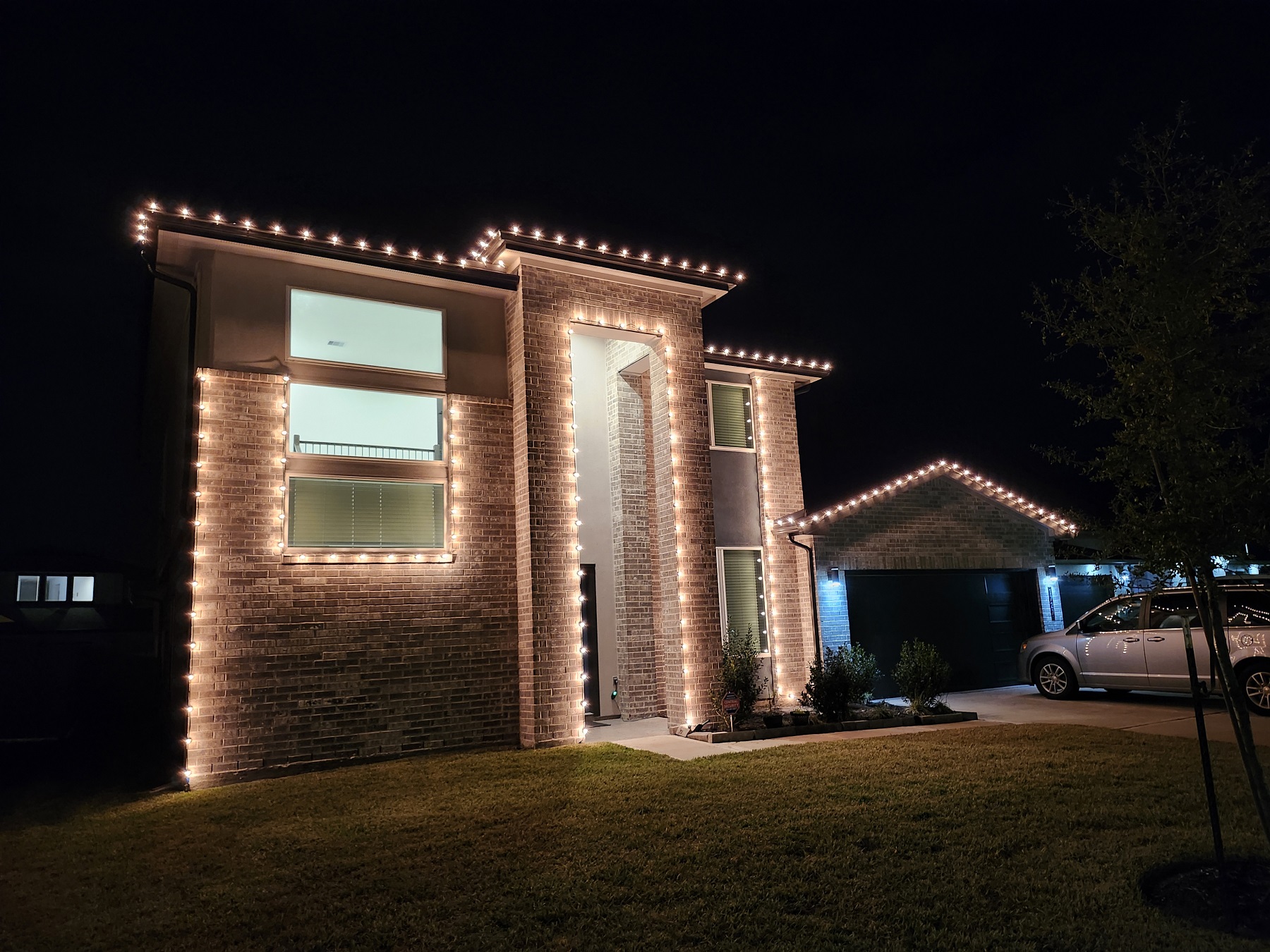 Christmas lights installation on two-story house in Katy, TX. LED Warm white