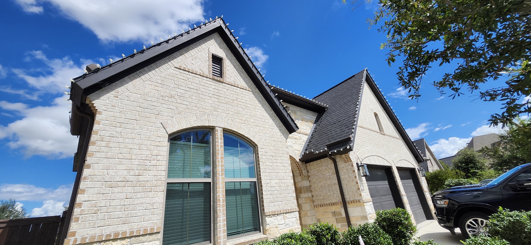 Christmas lights installation on two-story house in Katy, TX. LED Warm white